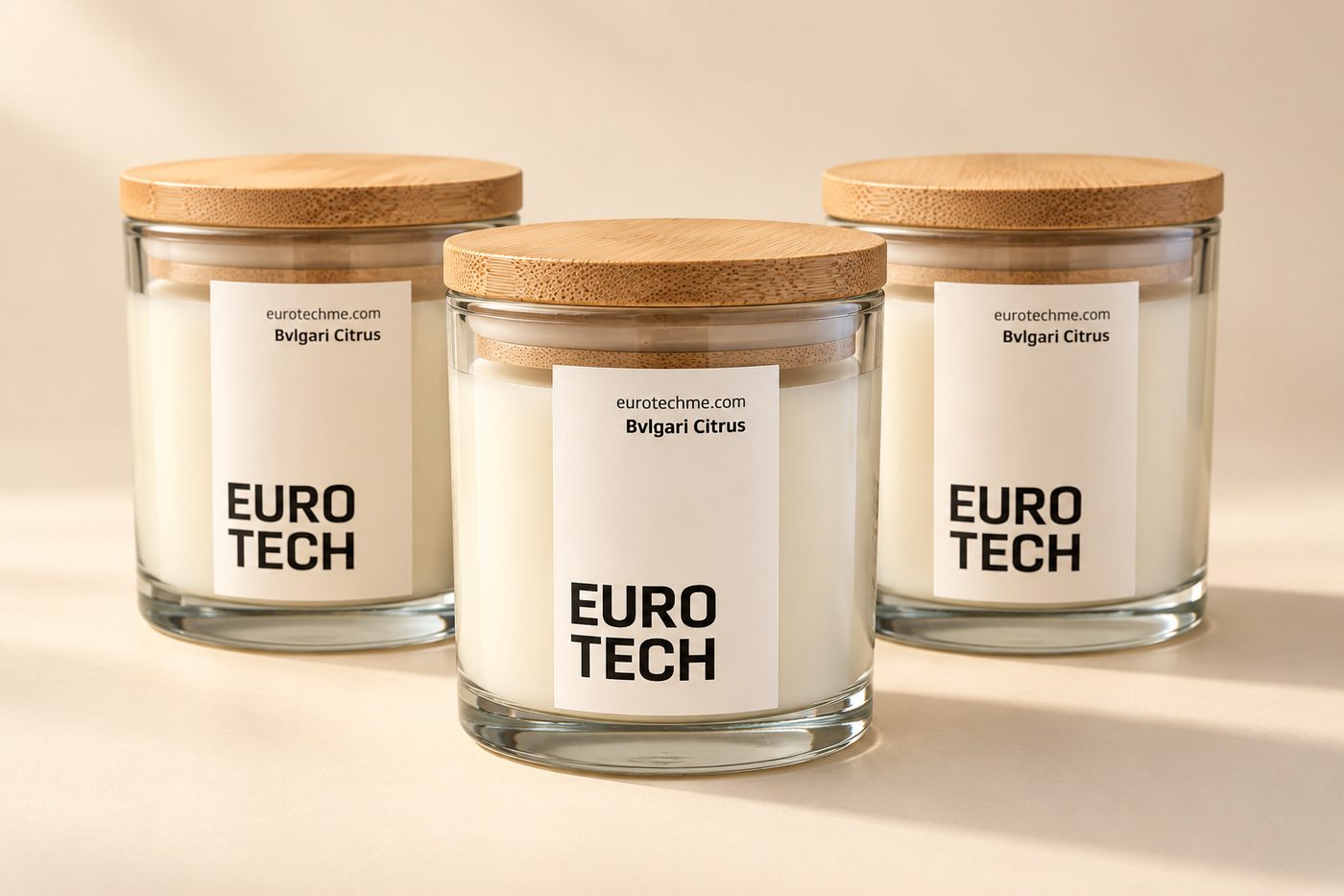 Three clear glass EURO TECH candles with bamboo lids and sticker labels
