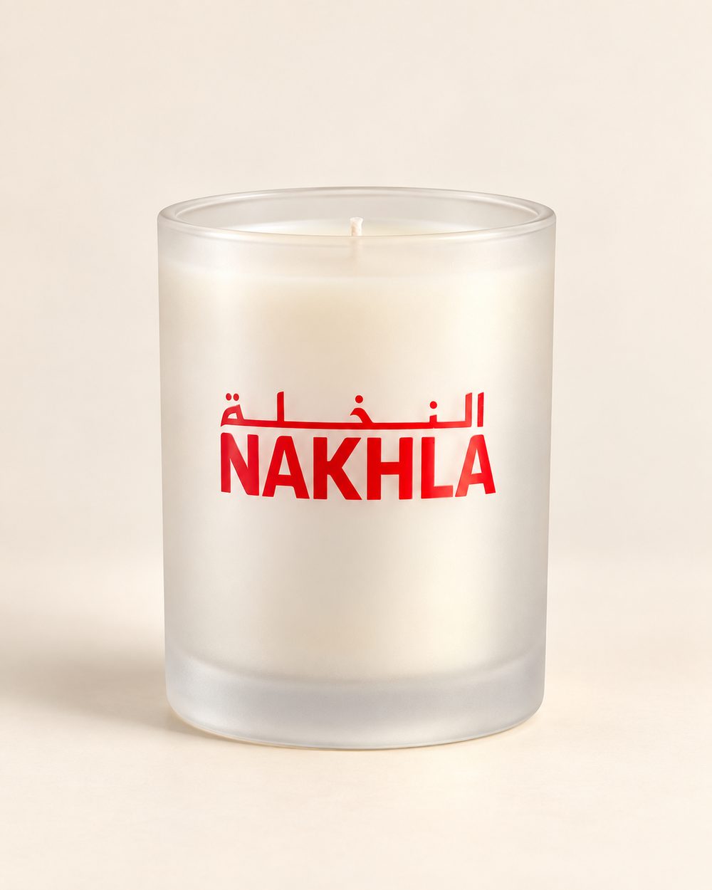 Frosted candle with red NAKHLA branding