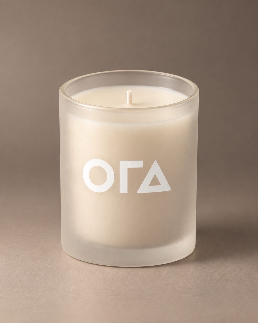 Frosted candle with white ORA logo
